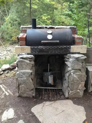 a small stove sitting on top of some rocks at STREAMSIDE CABIN IN THE CATSKILLS in Chichester