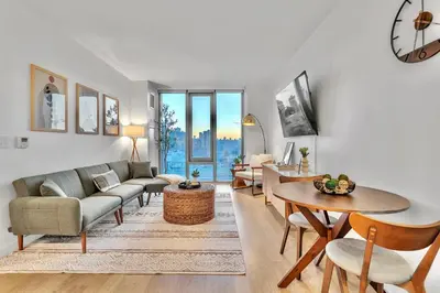 a living room with a couch and a table at Prime NYC Waterfront Gem in Mott Haven