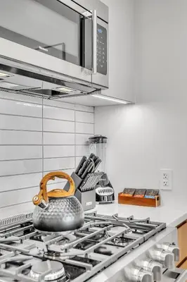 a kitchen with a stove with a pot on it at Prime NYC Waterfront Gem in Mott Haven