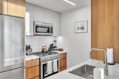 a kitchen with a stove and a microwave at Prime NYC Waterfront Gem in Mott Haven