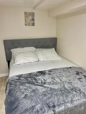 a bedroom with a large bed in a room at Z & Z Apartment 2 in Newark