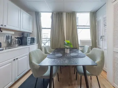 a kitchen with a table and chairs in a room at Sage Stay by the Train, We Pay Half Your Parking, 2 Queen Beds plus Sleeps 6 in Hoboken