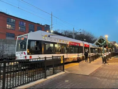 a train is on the tracks in a city at Sage Stay by the Train, We Pay Half Your Parking, 2 Queen Beds plus Sleeps 6 in Hoboken