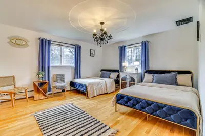 a bedroom with two beds and a couch at Game Room and Hot Tub! Cresco Family Home in Cresco