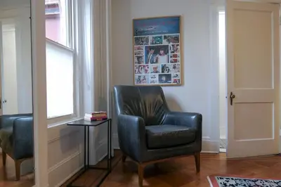 a black chair in a room with a table and a window at Garden Guest Suite in Brooklyn