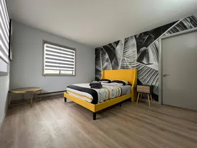 a bedroom with a yellow bed and a window at Elegant saver spot in Poconos in East Stroudsburg