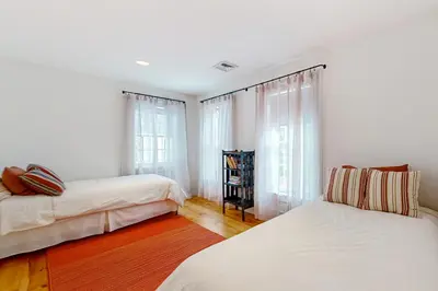 two beds in a room with white walls and windows at Close to Copake Lake! 4-Season Escape with Sauna in Copake Falls