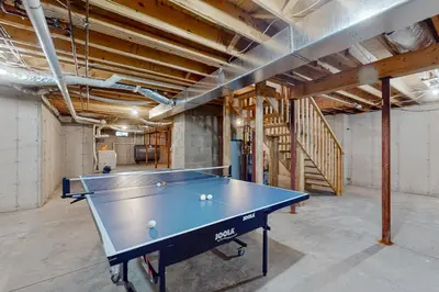 a ping pong table in an empty room at Close to Copake Lake! 4-Season Escape with Sauna in Copake Falls