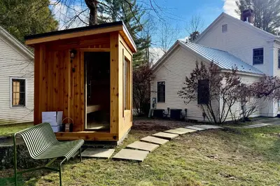 a wooden cabin in a yard next to a house at Close to Copake Lake! 4-Season Escape with Sauna in Copake Falls