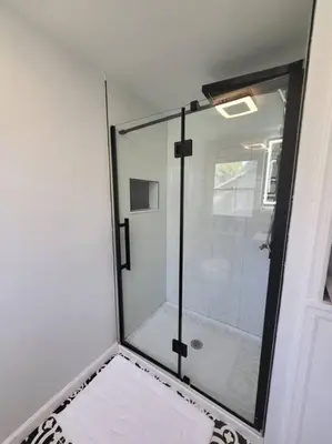 a shower with a glass door in a bathroom at Lake Luxe in Lake Ariel