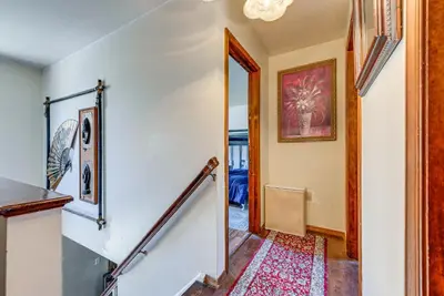 a staircase in a home with white walls at Tobyhanna Home with Fire Pit 1 Mi to Lake Carobeth! in Tobyhanna