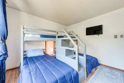a bedroom with a bunk bed with a ladder at Tobyhanna Home with Fire Pit 1 Mi to Lake Carobeth! in Tobyhanna