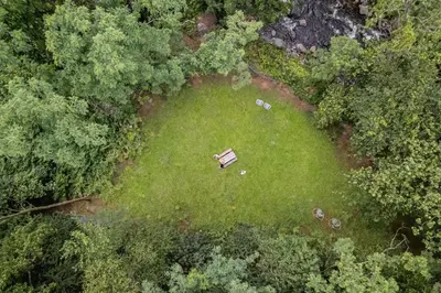 an overhead view of a park with a bench in the grass at Perch Eagle House - Creek Access, Sauna, Mt views in Boiceville