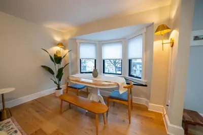 a dining room with a table and chairs and windows at Prime Location on Main Street in Stroudsburg