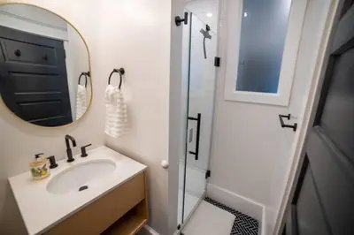 a bathroom with a sink and a mirror at Apt in the heart of Main Street in Stroudsburg