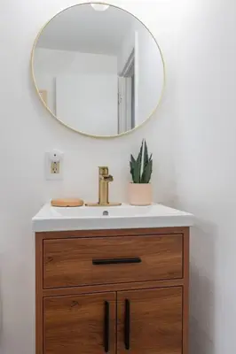 a bathroom with a sink and a mirror at Retro Retreat: 1br home w/ WFH desk, livingroom, and fire pit in Kingston