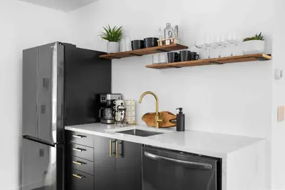a kitchen with a black refrigerator and a sink at Hudson Valley and The Berkshires Getaway in Hillsdale