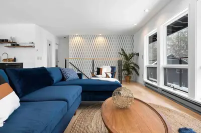 a living room with a blue couch and a table at Hudson Valley and The Berkshires Getaway in Hillsdale