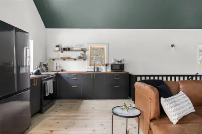 a living room with a couch and a kitchen at Hudson Valley and The Berkshires Cottage in Hillsdale