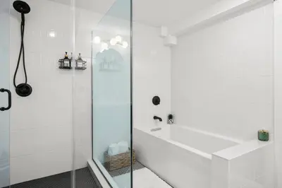 a white bathroom with a shower and a sink at Hudson Valley and The Berkshires Cottage in Hillsdale