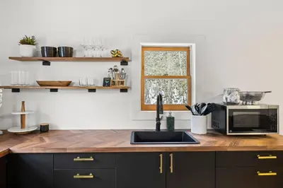 a kitchen with a counter with a sink and a microwave at Hudson Valley and The Berkshires Cottage in Hillsdale