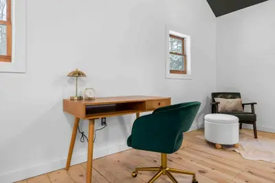 an office with a desk and a green chair at Hudson Valley and The Berkshires Cottage in Hillsdale