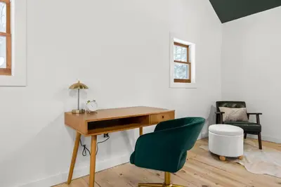 an office with a desk and a green chair at Hudson Valley and The Berkshires Cottage in Hillsdale