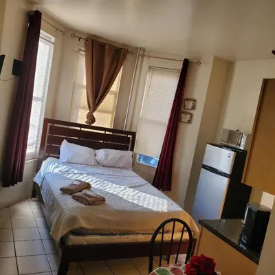 a bedroom with a bed with two towels on it at New Studio apartments Available Now!! in Port Morris