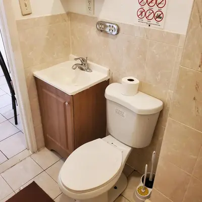 a bathroom with a toilet and a sink at New Studio apartments Available Now!! in Port Morris