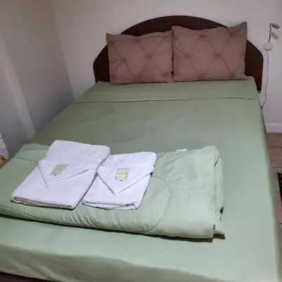 a bed with two towels and two pillows on it at New Studio apartments Available Now!! in Port Morris