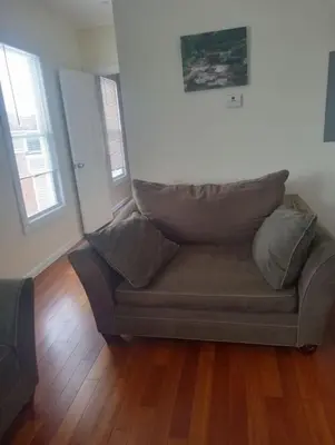 a couch with pillows on it in a living room at godlyone bedroom free parking in Schenectady