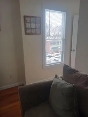 a living room with a couch and a window at godlyone bedroom free parking in Schenectady