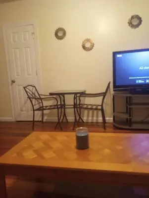 a living room with a table and a flat screen tv at simple one bedroom free parking in Schenectady
