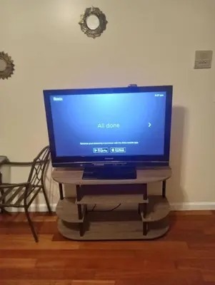 a flat screen tv sitting on a tv stand at simple one bedroom free parking in Schenectady