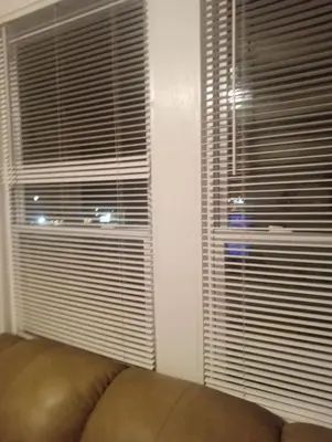 a couch sitting in front of two large windows at simple one bedroom free parking in Schenectady