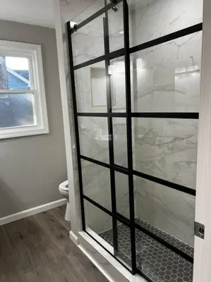 a glass shower door in a bathroom with a toilet at Esopus Creekside in Lake Katrine