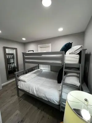 a bedroom with two bunk beds in a room at Esopus Creekside in Lake Katrine