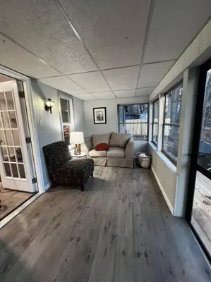 a living room with a couch and a chair at Esopus Creekside in Lake Katrine