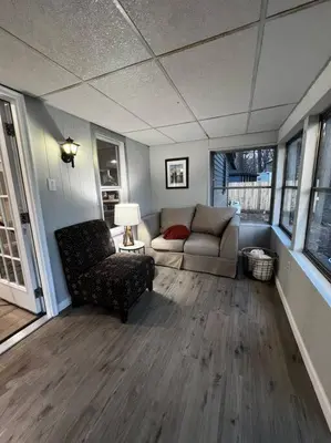 a living room with a couch and a chair at Esopus Creekside in Lake Katrine