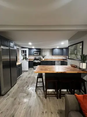 a kitchen with a large wooden table in a room at Esopus Creekside in Lake Katrine