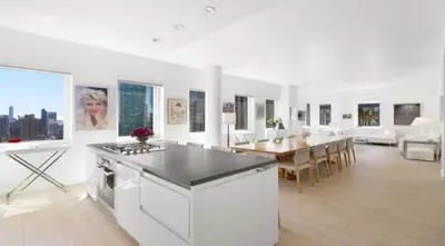 a white kitchen and dining room with a dining table at Exclusive Apartment Midtown Manhattan NYC Luxury Penthouse Sleeps 8 in New York