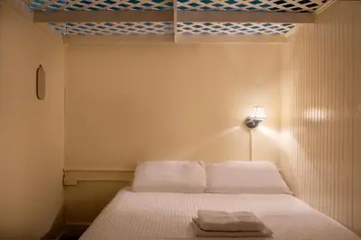 a bedroom with a bed with two towels on it at The Nolita Express Hostel in New York