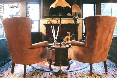 a living room with two chairs and a table at The Nolita Express Hostel in New York