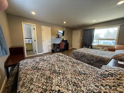 a hotel room with two beds and a large window at Heidi's Inn in Brewster