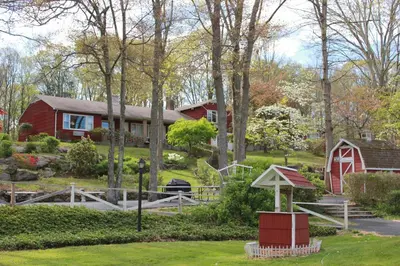 a house with a red barn and a yard at Heidi's Inn in Brewster