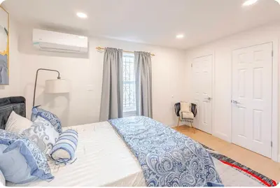 a bedroom with a bed with blue and white sheets at Exquisite 3 Bedrooms in Newark