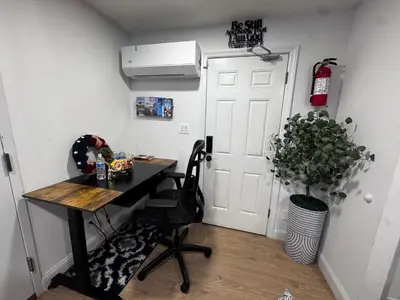 a small room with a desk and a door at Exquisite 3 Bedrooms in Newark