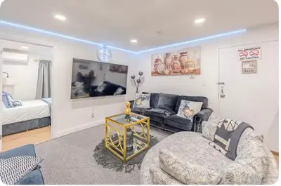 a living room with a couch and a chair at Exquisite 3 Bedrooms in Newark