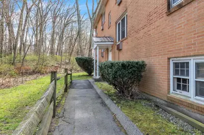 a sidewalk next to a brick building with a fence at Central Chic Crib in Manchester