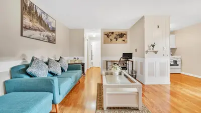 a living room with a blue couch and a table at Central Chic Crib in Manchester